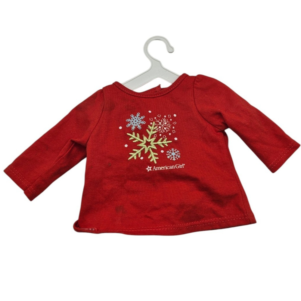 American Girl doll-sized red holiday top featuring a festive snowflake